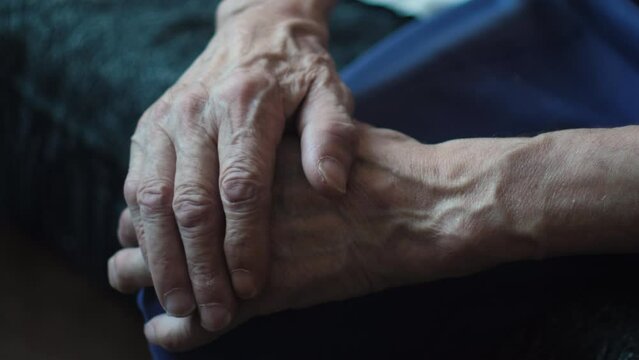 Old age in details, Wrinkled hands of an old man close-up. Symbols of experience: Worn hands as chronicles of life