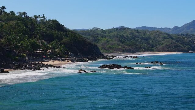 Palya Carricitos in Sayulita Mexico seen by a low flying drone across the water