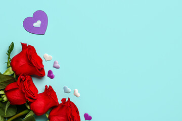 Red roses with paper hearts on blue background. Valentine's day concept