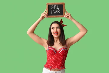 Foto op Canvas Beautiful young happy pin-up woman holding blackboard with text GIRL POWER on green background © Pixel-Shot