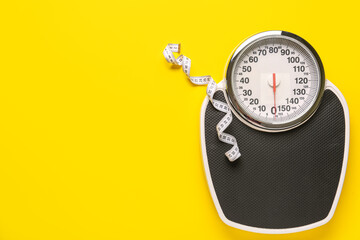 Scales with white measuring tape on yellow background