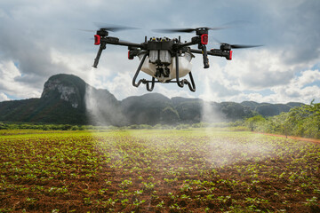 An industrial drone on green field and sprays useful pesticides to increase productivity and...