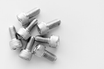 Hex socket head cap screw stainless steel allen bolts full thread metric on white table. Copy space.