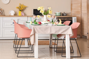 Interior of stylish kitchen with festive Easter table setting