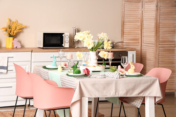 Interior of stylish kitchen with festive Easter table setting
