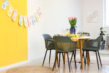 Interior of stylish dining room with festive Easter table setting