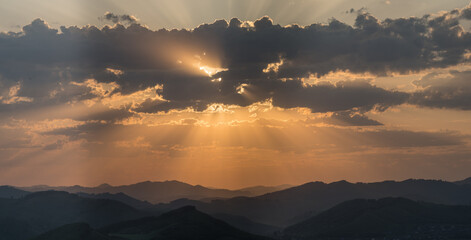 Picturesque sunrise in the mountains, sun rays	