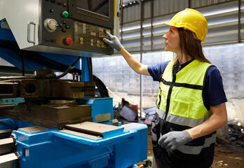 technician or engineer working and checking lathe machine in the factory