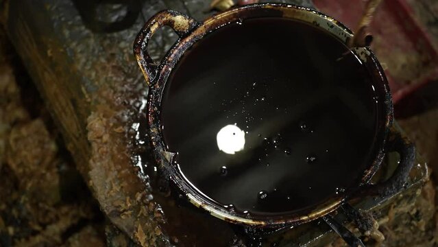 Close up of hand taking a night in frying pan with canting