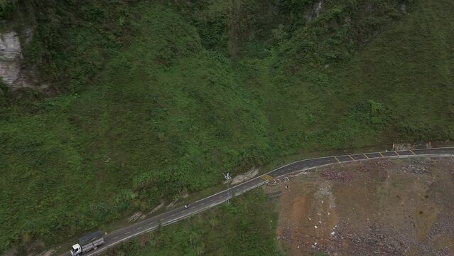 Rising drone shot of the Ma Pi Leng pass, rising up into the clouds.