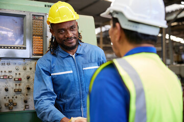 technician or engineer shaking hands with coworker before starting work in the factory