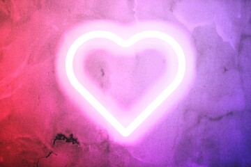 Neon heart glow on the wall background