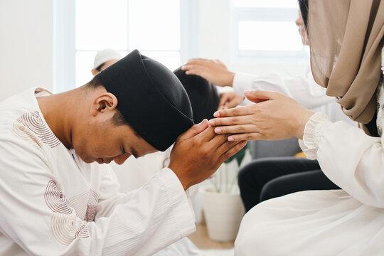 Asian Moslem man visiting parents to beg for forgiveness during Ramadan month or Eid mubarak moment