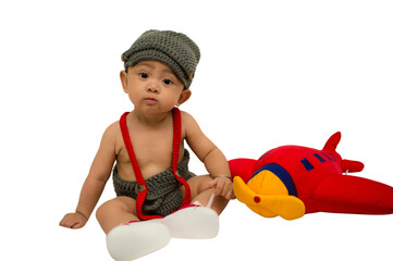 Happy and cute 6 months baby boy with red airplane toys