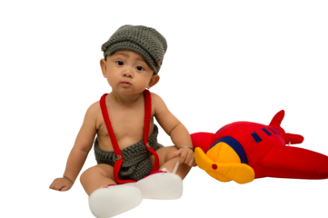 Happy and cute 6 months baby boy with red airplane toys