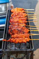Thailand street food , Spicy chicken satay on barbecue grill.