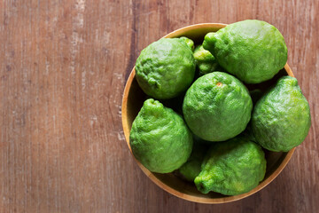 Bergamot, kaffir, fresh bergamot in wooden bowl on table, healthy, herb, herbal concept.