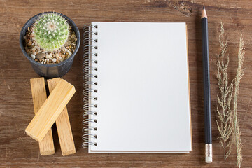 Pencil and notebook on wooden table background