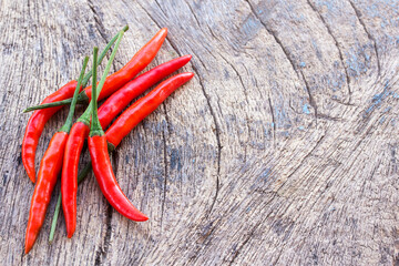 Fresh red chili on an old wooden background.