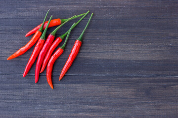 Fresh red chili on an old wooden background.