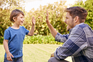 High five, kid and man in park for family adventure, support and motivation with development. Dad, boy child and happy with excited hand gesture for success, teamwork and happiness together in garden