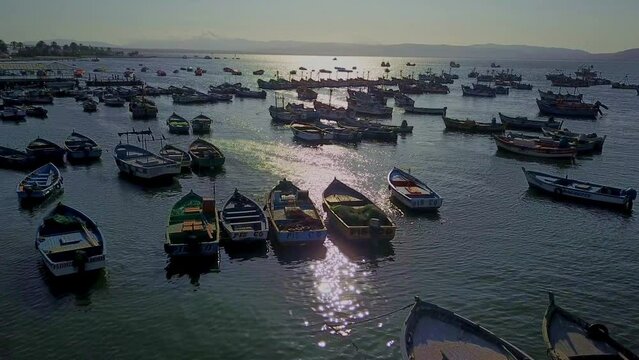 Fishing Boats at El Chaco Bay in Peru with Sunlight Reflecting On the Water, Aerial Drone Shot.