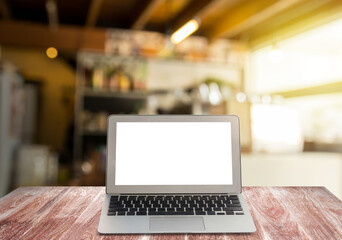 Blank screen laptop on wooden shelves