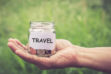 Hands holding money in the jar. save money for travel funds