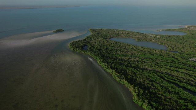 Fast sailing speedboat on the Bioluminiscencia on the island Holbox in Mexico. Drone view