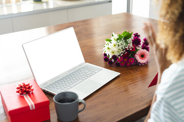 Biracial woman at home preparing for an online video date, with copy space