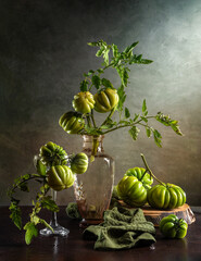 Modern still life with a bouquet of green tomatoes on a dark background