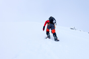 Mountaineer climbing in snowy mountains.