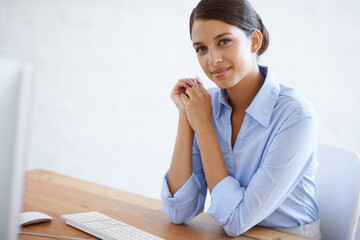 Happy, portrait and professional woman at desk in office with computer as clerk or happy secretary in administration. Business, assistant and employee ready to start on project with confidence