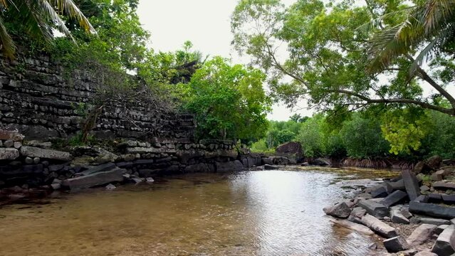 The outer stone walls of the ancient city of Nan Madol surrounded by lagoon canal in Pohnpei, Federated States of Micronesia