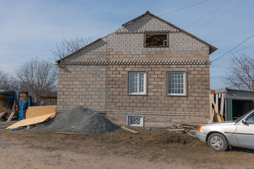 Consequences of a rocket explosion on a private house. War in Ukraine. Remains of a private house...