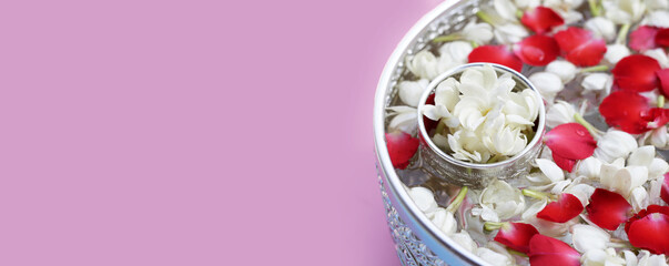 Water with jasmine flower and rose petal in silver bowl. Thai tradition, Songkran festival concept
