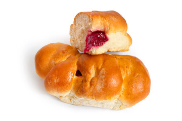 Sweet buns stuffed with berry jam on a white background. A whole loaf and half a loaf.