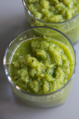 Celery smoothie, apple and kiwi in a clear glasses