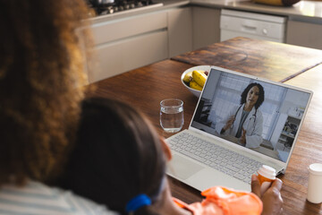 Biracial woman consults with a doctor online from home