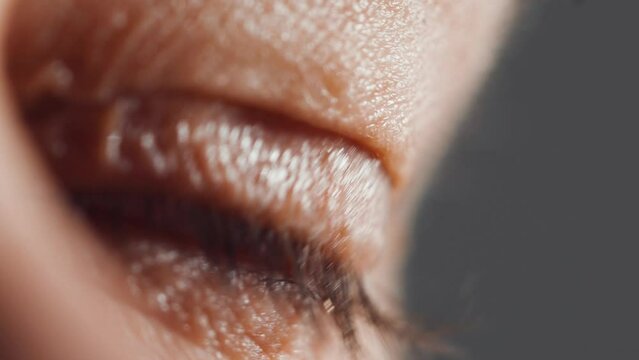 Blinking human eye with beautiful brown iris, clear vision, Close up