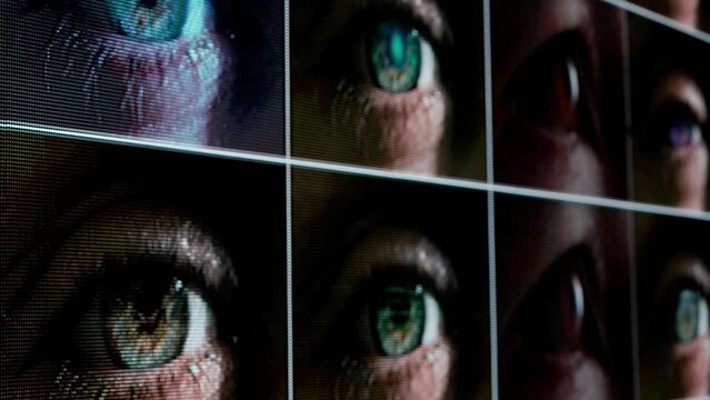 Shot of human eyes background video. Collage of peoples open eyes with text digitals running through, looking from pixel screen.