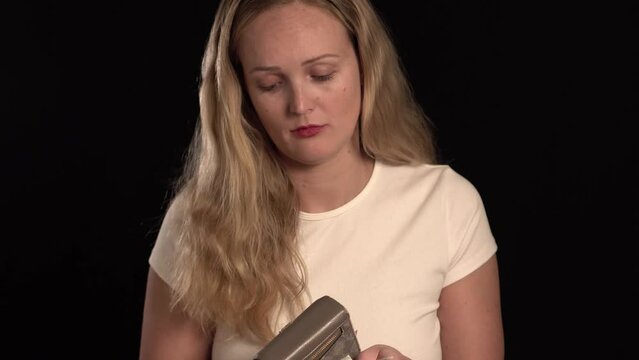 European blonde girl having problems with her money. She is unhappy. Couting money and being depressed about not having enough.