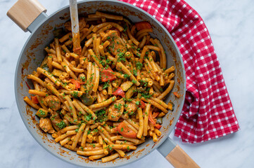 One pot pasta with chicken meat and vegetables in a skillet