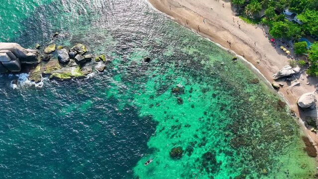 Koh Tao, a serene island in Thailand, boasts pristine beaches, crystal-clear waters, and vibrant marine life, making it a haven for snorkelers and divers alike. Drone aerial view. Cinematic footage. 
