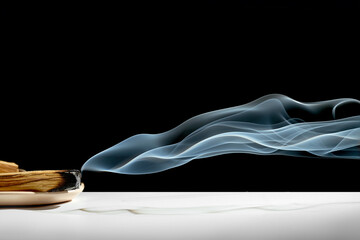 A block of Palo Santo wood is burning. Aromatic smoke for meditation and healing