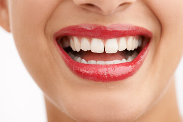 Woman, teeth and red lipstick with makeup for beauty, cosmetics or dental care on a white studio...