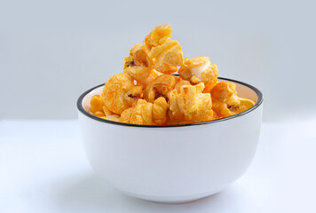 Popcorn with cheddar cheese in round ceramic bowl on the table. Delicious cheese popcorn