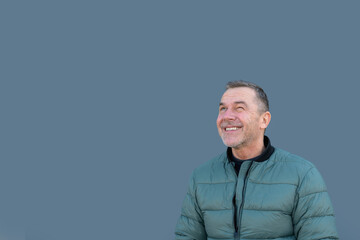 Upper body portrait of a middle aged man looking up with a critical look