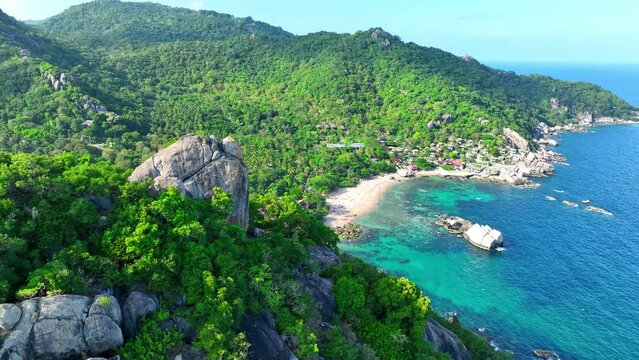 Discover the allure of Koh Tao with its stunning beaches, crystal-clear waters, and world-class diving. An island escape like no other. Aerial view. Sea stock footage. Tropical background. 4K.

