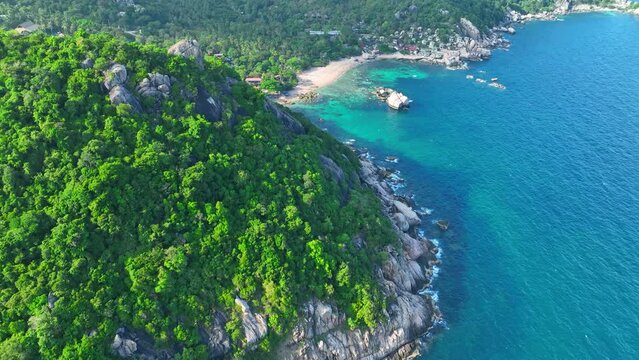 Escape to Koh Tao's idyllic shores, where crystal-clear waters beckon adventurers to snorkel, dive, and unwind amidst stunning natural beauty. Bird's eye view. Nature stock footage. 4K HDR. 
